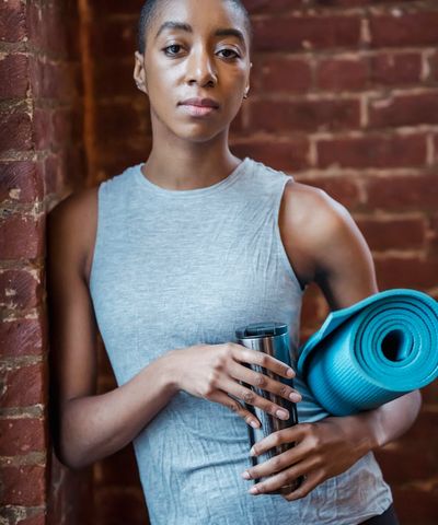 Close-up of a yoga mat and a water bottle in a calm, well-lit space.